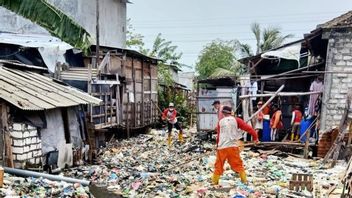 The Dirty Kalianak River, Surabaya, Is Filled With Plastic And Baby Diapers To Make The Water Invisible