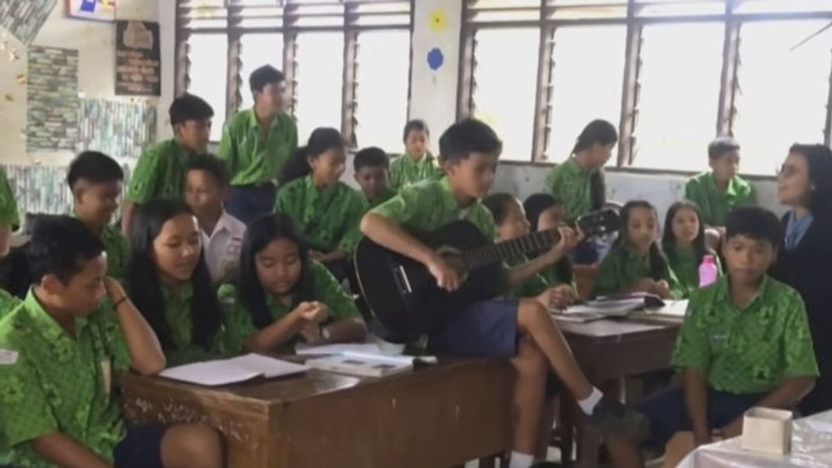 Un élève de l’école primaire de Karo Chantant une chanson radja, Ian Kasela donne une réponse