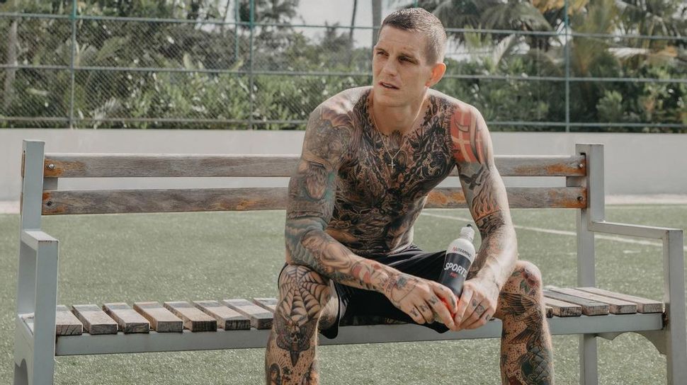 Danish international footballer Daniel Agger exposes his body tattoos after  the match against England | Sportimage