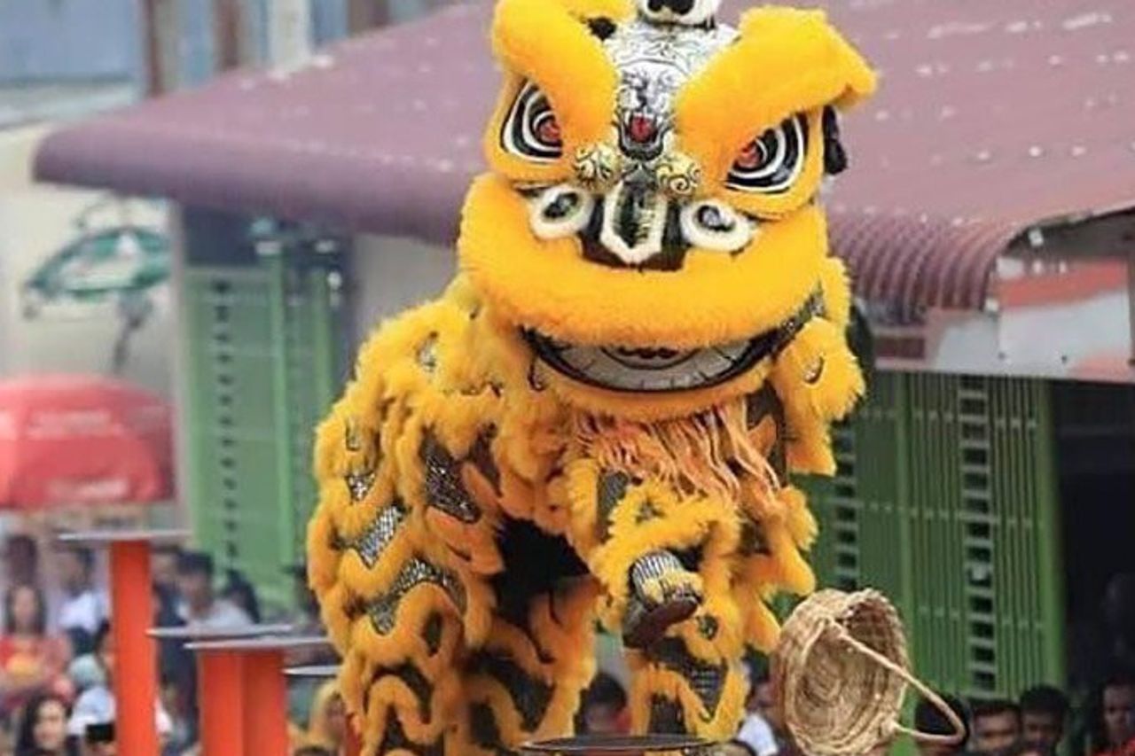 Entertainers perform lion dance during the opening ceremony of the