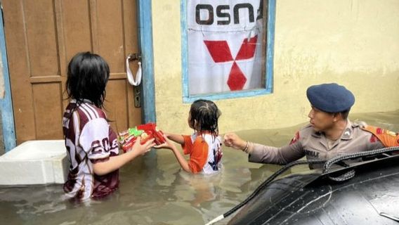 Brimob Polda Metro Jaya aide à évacuer les victimes des inondations à Cakung
