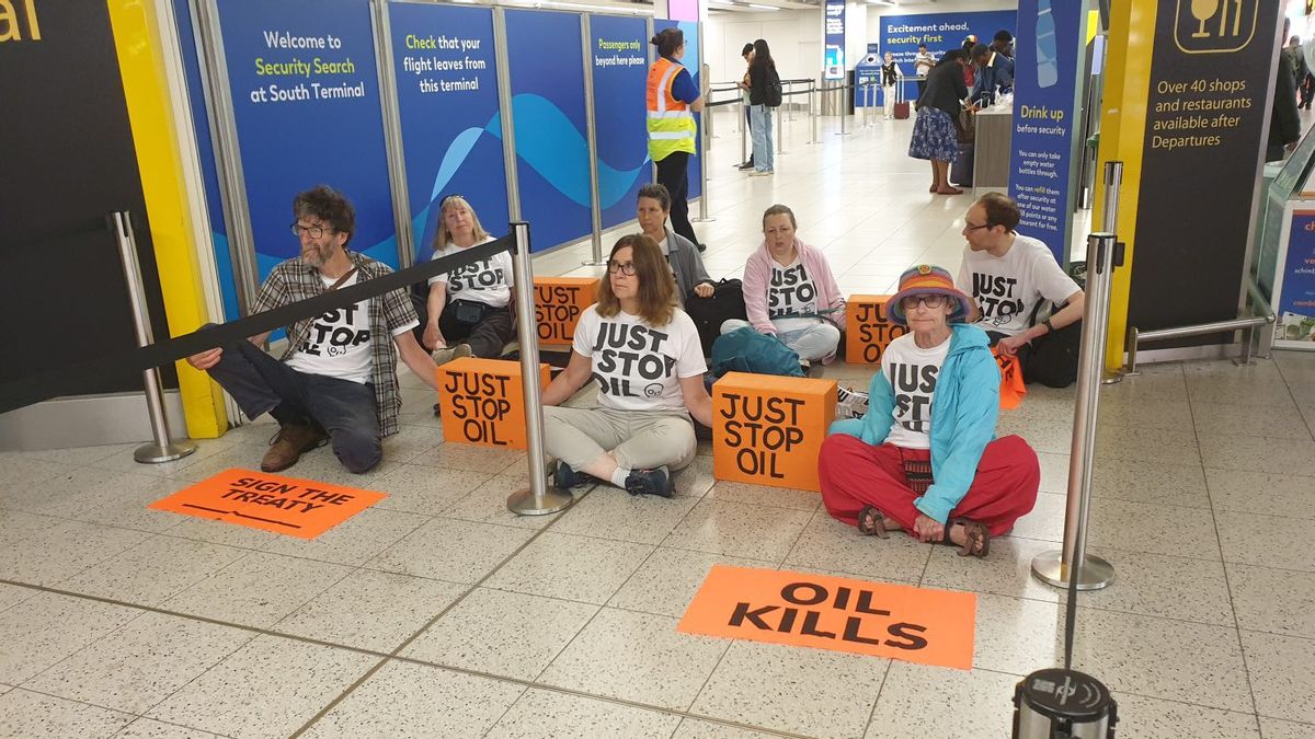 British Activist Breaks Through Airport, Lined Up Sitting At Gate Of Departure Blocking Passengers